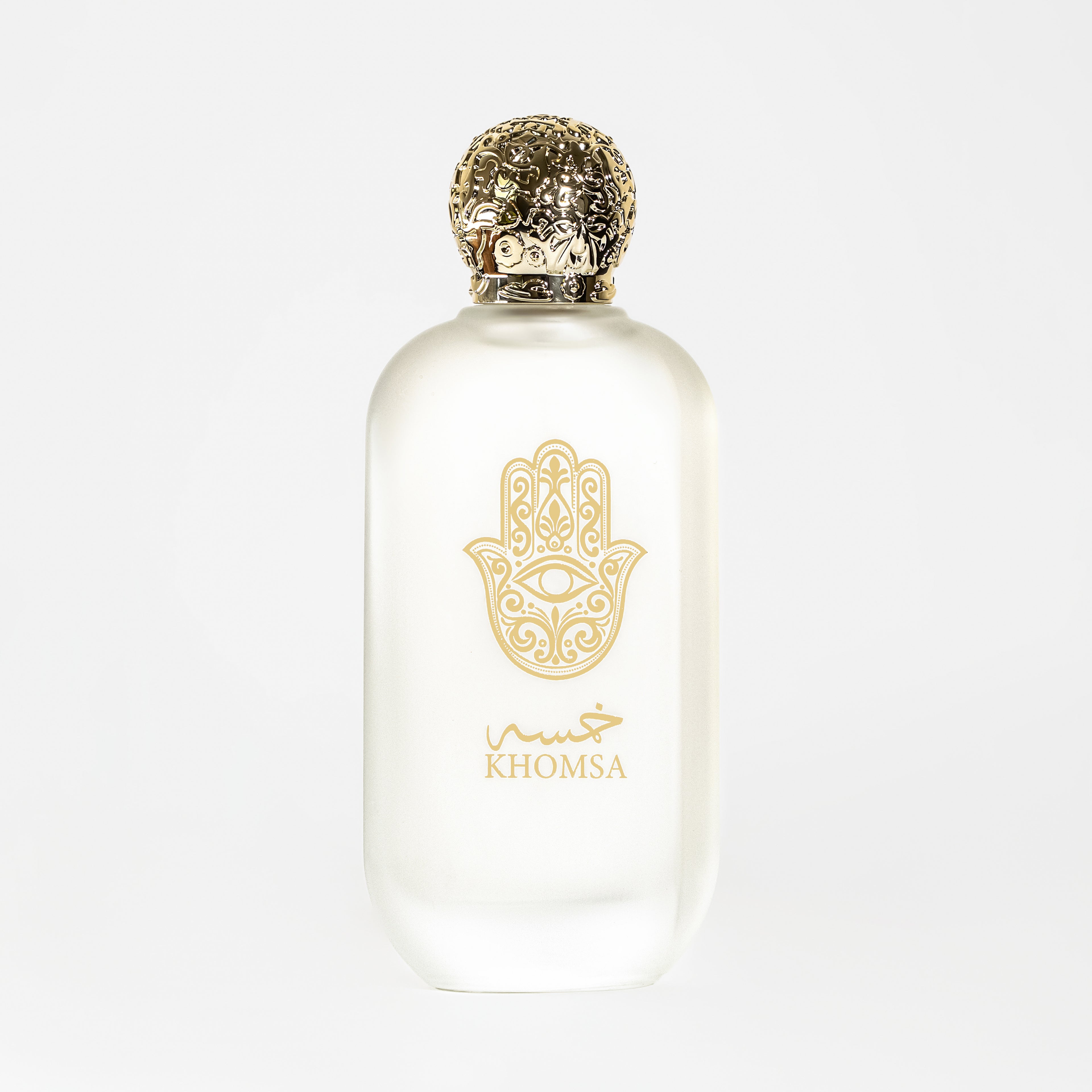 White perfume bottle with gold cap and 'Khomsa' logo on a white background